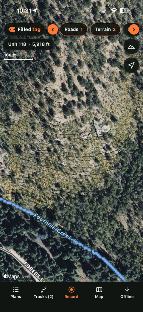 The FilledTag app showing black contour lines and a creek over an aerial photo